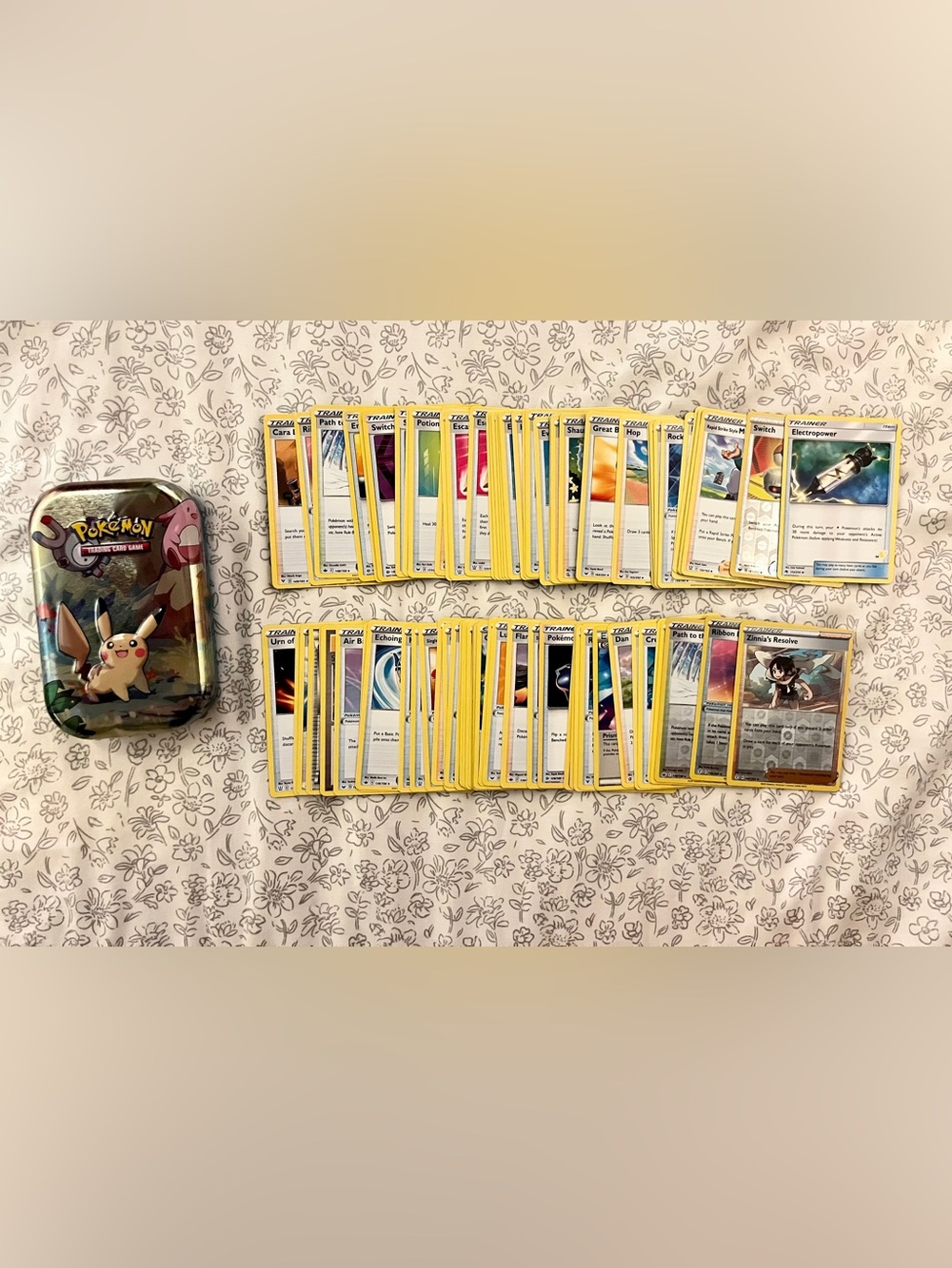 Pokemon tin with stack of trainer cards!
